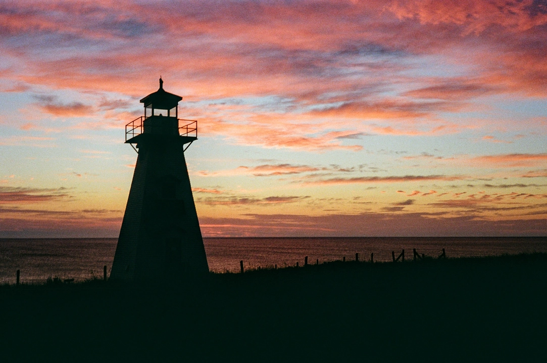 A picture of a lighthouse at sunrise