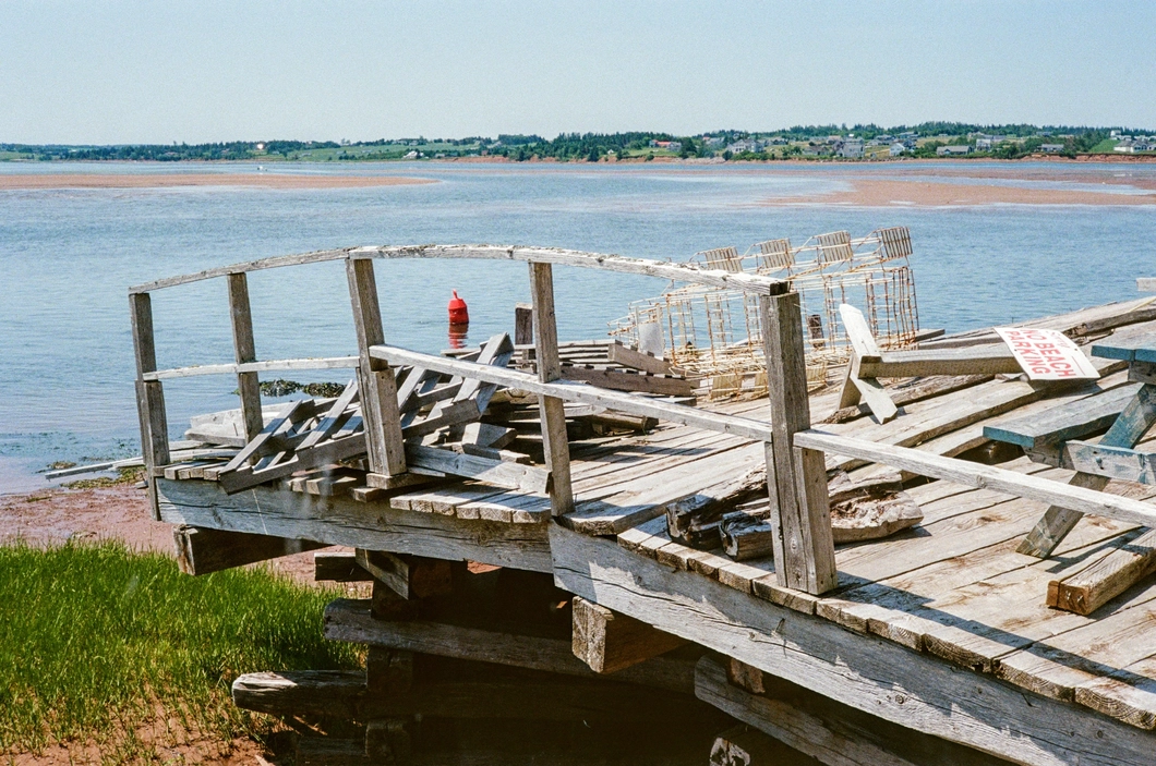 A picture of a broken pier by a lake