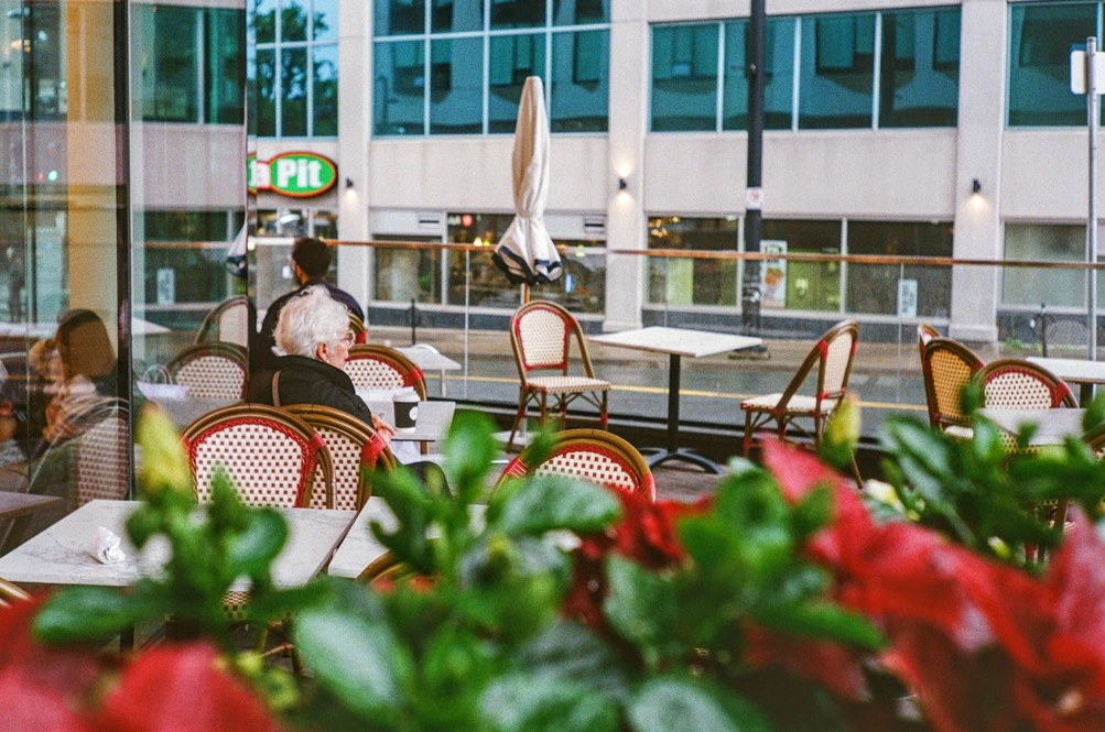 A picture of an older woman sitting at a patio